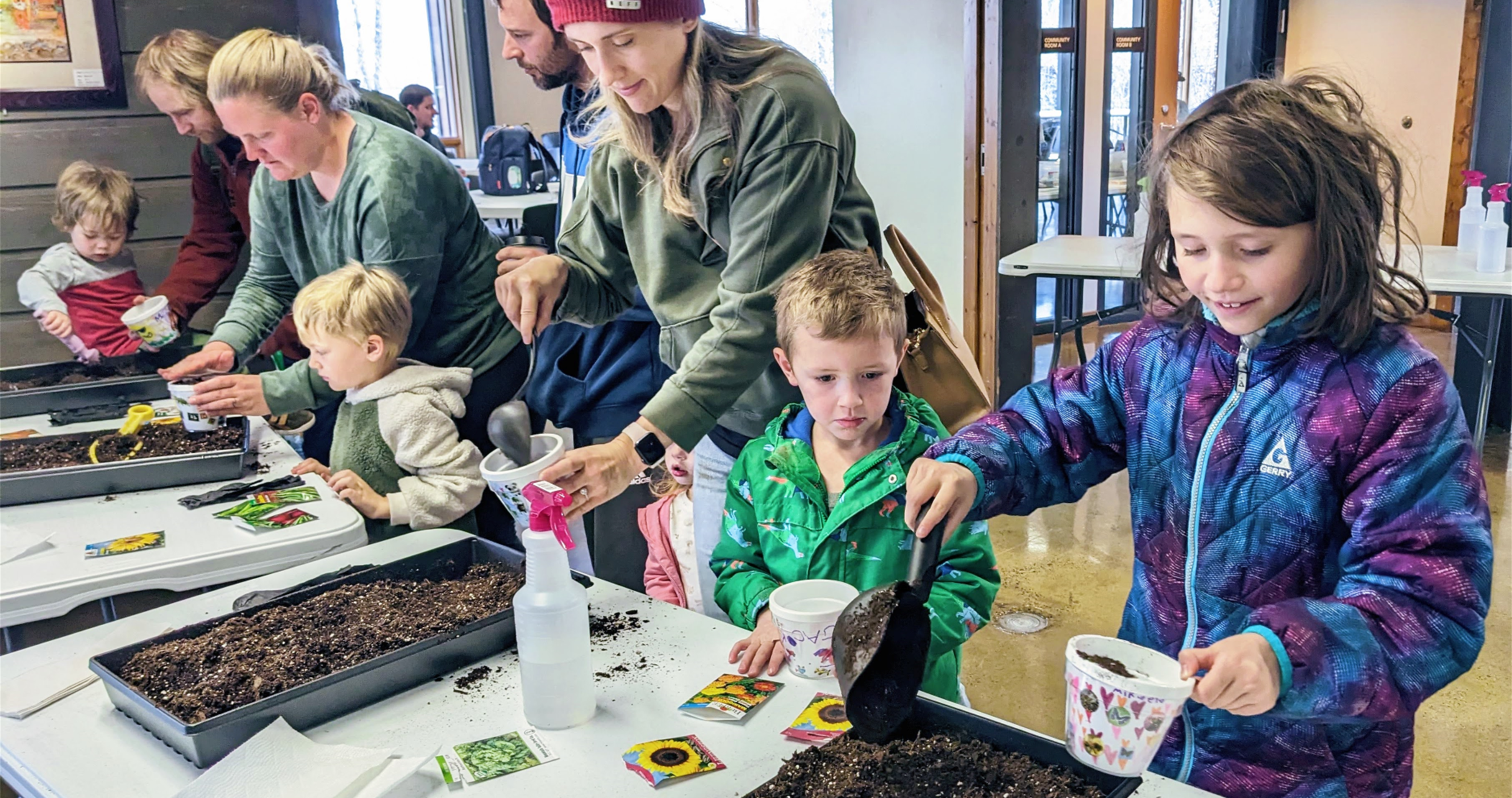 Kids fill their containers with soil